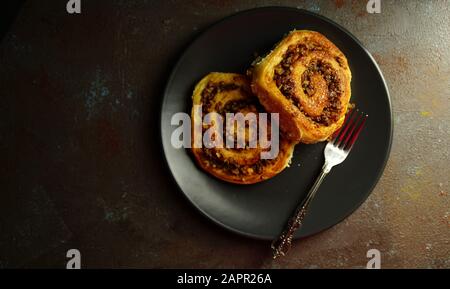 Concept of bavarian food. Homemade sweet yeast dough brioches filled with chopped nuts. Snail buns with nuts, Nussschnecken Stock Photo