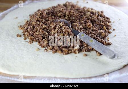 Closeup of stuffed with chopped walnuts with sugar on leavened dough. Stock Photo