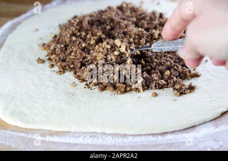 Closeup of stuffed with chopped walnuts with sugar on leavened dough. Stock Photo
