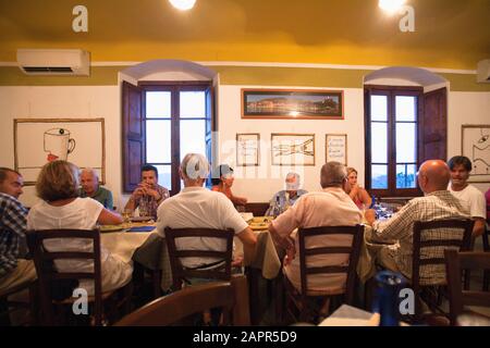 Italy Liguria Lerici - Friends Dining in Osteria L'Orto di Amneste Restaurant Stock Photo