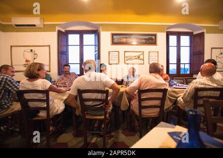 Italy Liguria Lerici - Friends Dining in Osteria L'Orto di Amneste Restaurant Stock Photo