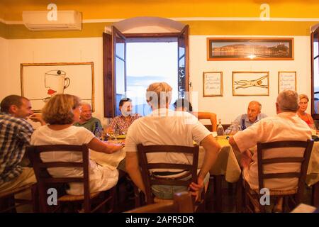 Italy Liguria Lerici - Friends Dining in Osteria L'Orto di Amneste Restaurant Stock Photo