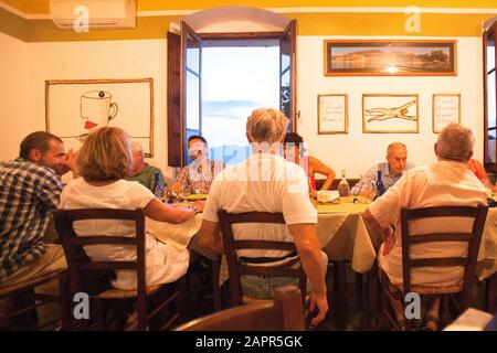 Italy Liguria Lerici - Friends Dining in Osteria L'Orto di Amneste Restaurant Stock Photo