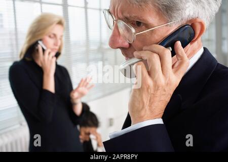 Businesspeople using cellphone. Stock Photo