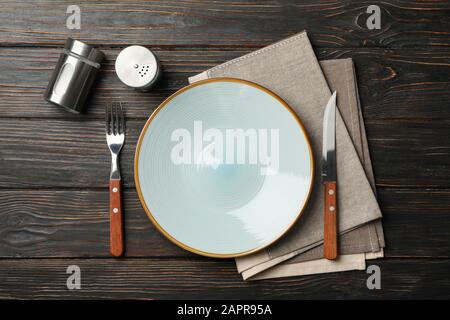 Table setting with spices and towel on wooden background, top view Stock Photo