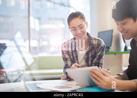 Multiethnic students working at the table with digital tablet they preparing for the homework together Stock Photo