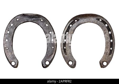 Horseshoe isolated. Close-up of metal horse shoe as a symbol of good luck, prosperity and of a happy future isolated on a white background. Macro phot Stock Photo