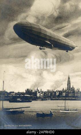 Photo of the first aerial bombardment ever: A German Zeppelin bombed the city of Antwerp in Belgium on the night of 24 to 25 August 1914, at the beginning of the First World War. In the foreground the big cigar shape of the rebuked zeppelin, in the background the burning city. Stock Photo