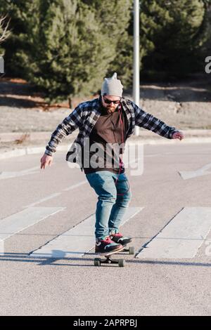 Young man longboarding in the street. Skateboarding concept. Stock Photo
