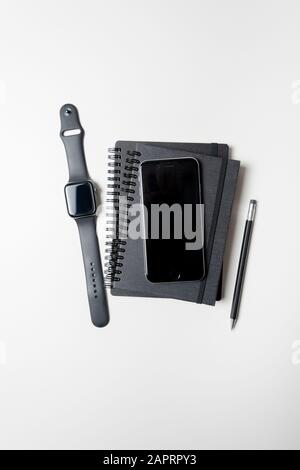Apple Watch, iPhone & note pads isolated on a white background. January 2020. Please credit: Phillip Roberts Stock Photo
