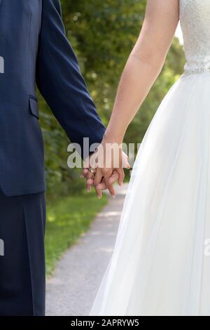 Bride and groom at marriage hold each other, closeup of hands Stock Photo