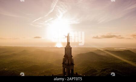 statue of Christ standing on a pedestal, The Balearic islands, Spain Palma de Mallorca, huge old statue on a hill during sunrise early in the morning Stock Photo