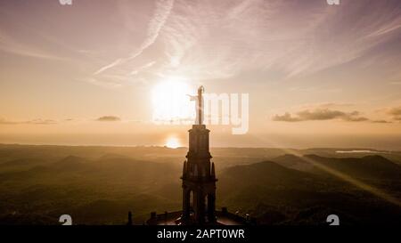 statue of Christ standing on a pedestal, The Balearic islands, Spain Palma de Mallorca, huge old statue on a hill during sunrise early in the morning Stock Photo