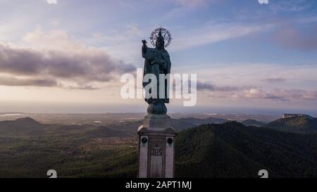 statue of Christ standing on a pedestal, The Balearic islands, Spain Palma de Mallorca, huge old statue on a hill during sunrise early in the morning Stock Photo