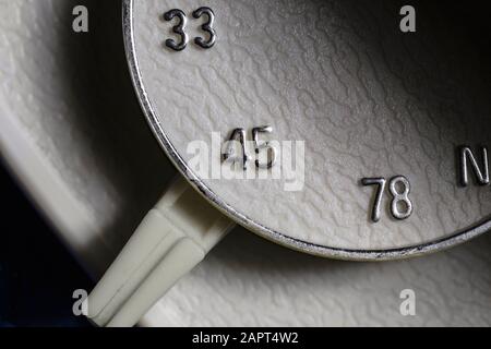 Macro close up photograph of 33, 45 or 78 rpm selector switch on vintage record player turntable. Stock Photo