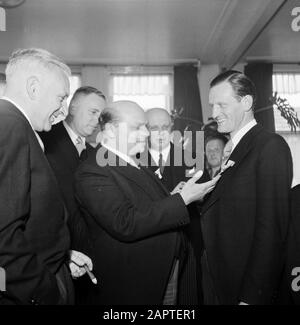 50th anniversary cigar factory Karel I Eindhoven  Group men looks at the award of factory director Albert van Abbe Annotation: At the 50th anniversary of the N.V. Karel I Cigar factories Director Albert van Abbe was appointed Officer in the Order of Orange Nassau Date: 1 January 1950 Location: Eindhoven Keywords: directors, factories, awards, smoking, tobacco industry Personal name: Abbe, Albert van Stock Photo