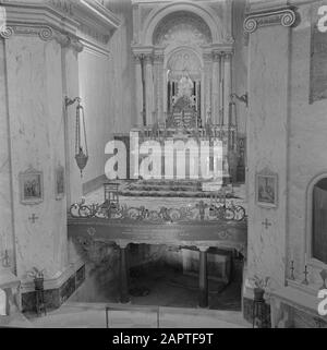 Israel 1948-1949: Haifa  Haifa. Interior of the church of the Carmelite Monastery Stella Maris. View of the high altar with a statue of O.L.Lady of Mount Carmel with below the cave in which the prophet Elijah would have stayed Date: 1948 Location: Haifa, Israel Keywords: Marian worship, altars, architecture, interior, candles, carmelites, church buildings, monasteries, neobarok, Pillars Personal Name: Elia, Prophet Institutional Name: Stella Maris Stock Photo