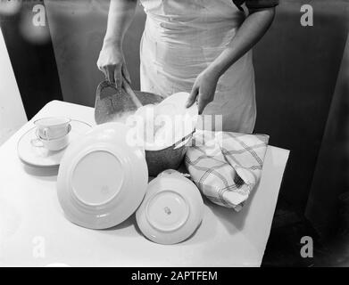 Advertising photography  Woman's hands washing dishes Date: January 1, 1932 Keywords: hands, household, tableware Stock Photo