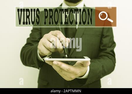 Handwriting text writing Virus Protection. Conceptual photo program designed to protect computers from malware Male human wear formal work suit hold s Stock Photo