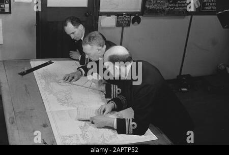 Dutch minesweepers  Headquarters of Minesweepers Command [Command Minesweepers]. Plotting the position of newly laid enemy mines. In the middle the British commander, next to him the Dutch commander (dark hair), and his British deputy Date: March 1942 Keywords: navy, officers, ships, World War II Stock Photo