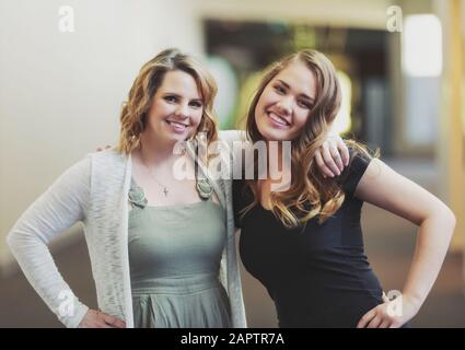 A young woman and her youth leader posing for a picture in a hallway of a church: Edmonton, Alberta, Canada Stock Photo