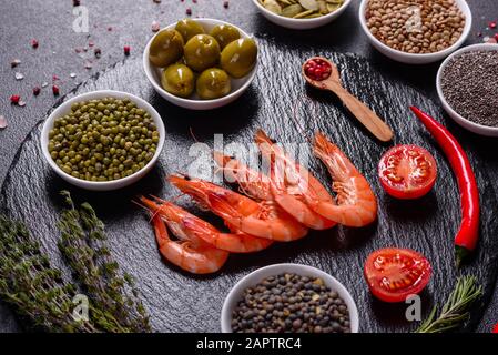 Fine selection of jumbo shrimps for dinner on stone plate. Food background Stock Photo