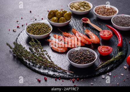 Fine selection of jumbo shrimps for dinner on stone plate. Food background Stock Photo