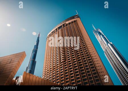 Luxury downtown of Dubai, bottom view on modern futuristic buildings, contemporary city, UAE
