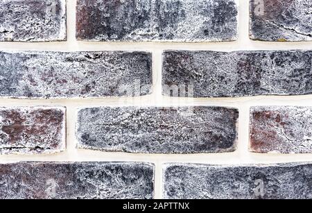 Decorative brick wall from of brown bricks. Background and texture of brickwork. Stock Photo