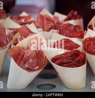 Wooden bags with slices of sausage and bacon on the counter at a fair in the South of France Stock Photo