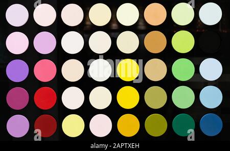 Circles with a color palette on a black glossy background. ?olor palette from saturated colors to neutral. Stock Photo