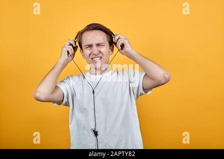 Man in headphones aggression Stress at work office Stock Photo