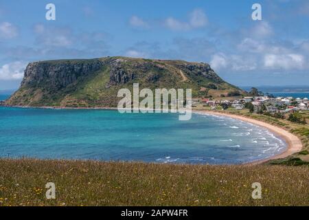 Stanley, Tasmania, Australia - December 15, 2009: The Nut volcanic plug and part of town under blue cloudscape. Stock Photo