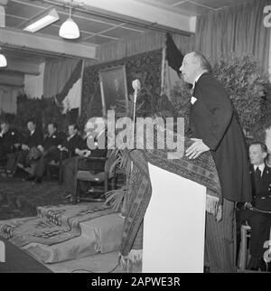 50th anniversary cigar factory Karel I Eindhoven  Man behind a catheder, in the background factory directors Jan and Albert van Abbe (2nd and 3rd from the left) sitting under the portrait of Henri van Abbe Annotation: The portrait of Henri van Abbe, founder of the Charlemagne I Cigar Factories, was made by Piet van der Hem. Date: 1 January 1950 Location: Eindhoven Keywords: directors, factories, microphones, paintings, tobacco industry, carpets Personal name: Abbe, Albert van, Abbe, Henri van, Abbe, Jan van Stock Photo