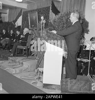 50th anniversary cigar factory Karel I Eindhoven  Man behind a catheder, in the background factory directors Jan and Albert van Abbe (2nd and 3rd from the left) sitting under the portrait of Henri van Abbe Annotation: The portrait of Henri van Abbe, founder of the Charlemagne I Cigar Factories, was made by Piet van der Hem. Date: 1 January 1950 Location: Eindhoven Keywords: directors, factories, microphones, paintings, tobacco industry, carpets Personal name: Abbe, Albert van, Abbe, Henri van, Abbe, Jan van Stock Photo