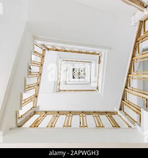 High angle view of a modern spiral staircase in an exhibition under the lights Stock Photo