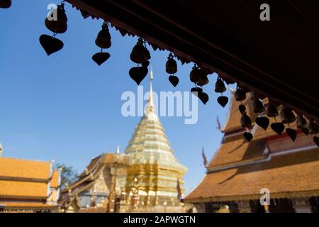 Silhouette of hanging bells with golden stupa in Wat Doi Suthep Stock Photo