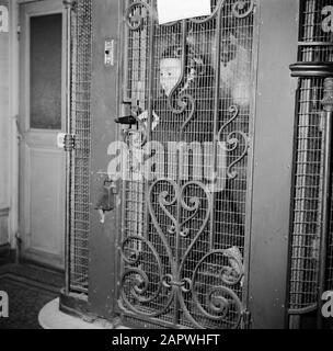 Residents of an apartment building in Paris  Girl standing in the elevator Date: 1950 Location: France, Paris Keywords: elevators Stock Photo