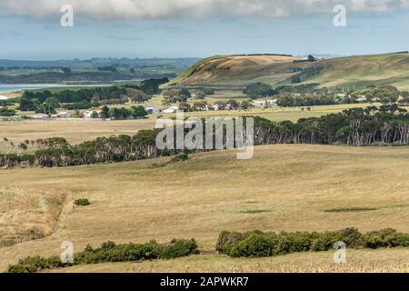 Stanley, Tasmania, Australia - December 15, 2009: Rural landscape with yellowish meadows and patches of green trees above The town. Hills and small pi Stock Photo