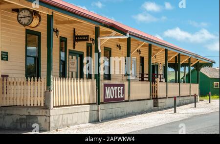 Stanley, Tasmania, Australia - December 15, 2009: The yellow and brown wooden building of Stanley Village Motel with clock under blue sky. Stock Photo