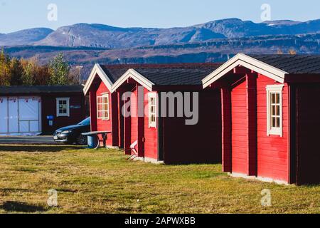 View of Classical Norwegian Camping site with traditional wooden red cottages, Northern Norway Stock Photo