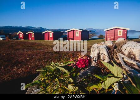 View of Classical Norwegian Camping site with traditional wooden red cottages, Northern Norway