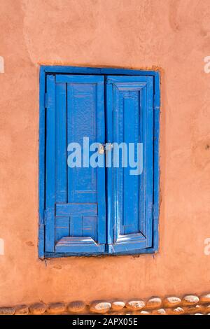 Blue door set in an adobe wall, San Pedro de Atacama, Chile Stock Photo