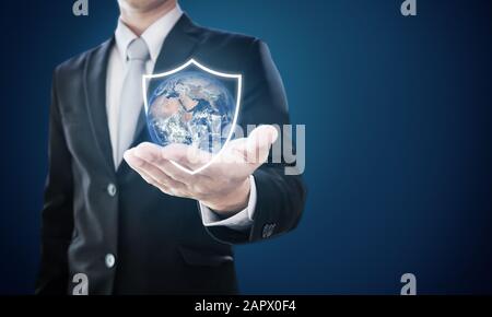 Businessman holding globe with shield icons. Protect the world and environmental conservation. Element of this image are furnished by NASA Stock Photo