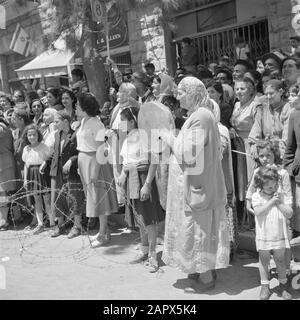 Israel 1948-1949: Jerusalem  Audience, including Bucharin women, one with a hand drum, during the military parade on May 15, 1949 in Jerusalem on the occasion of the first anniversary of Israel independence Date: 23 Apr 1950 Location: Israel, Jerusalem Keywords: children, military parades, national holidays, public, percussion instruments Stock Photo
