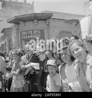Israel 1948-1949: Jerusalem  Audience, including a man blowing on a shofar (ram horn), at the military parade on May 15, 1949 in Jerusalem on the occasion of the first anniversary of Israel Independence Date: 23 Apr 1950 Location: Israel, Jerusalem Keywords: pharmacies, architecture, wind instruments, Jewish religion, children, military parades, national holidays, public, billboards Stock Photo