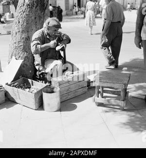 Israel: Bersheba  Shoemaker in the open air working with a shoe he has put on a read Date: undated Location: Beersheba, Bersheba, Israel Keywords: trade, shoes, shoemakers, street images Stock Photo