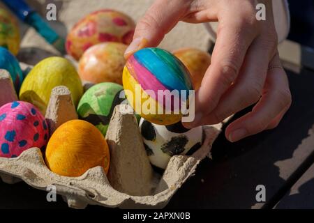 Painted easter eggs in an egg box, painting easter eggs, Bavaria, Germany Stock Photo