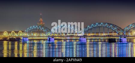 Railway bridge, Dzelzcela bridge, DzelzceÄ¼a tilts, over river Duena at night, Riga, Latvia Stock Photo