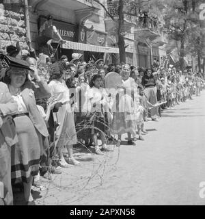 Israel 1948-1949: Jerusalem  Spectators, including a Bucharin woman with a hand drum, during the military parade on May 15, 1949 in Jerusalem on the occasion of the first anniversary of Israel independence Date: 23 Apr 1950 Location: Israel, Jerusalem Keywords: children, military parades, national holidays, barbed wire, public, percussion instruments Stock Photo